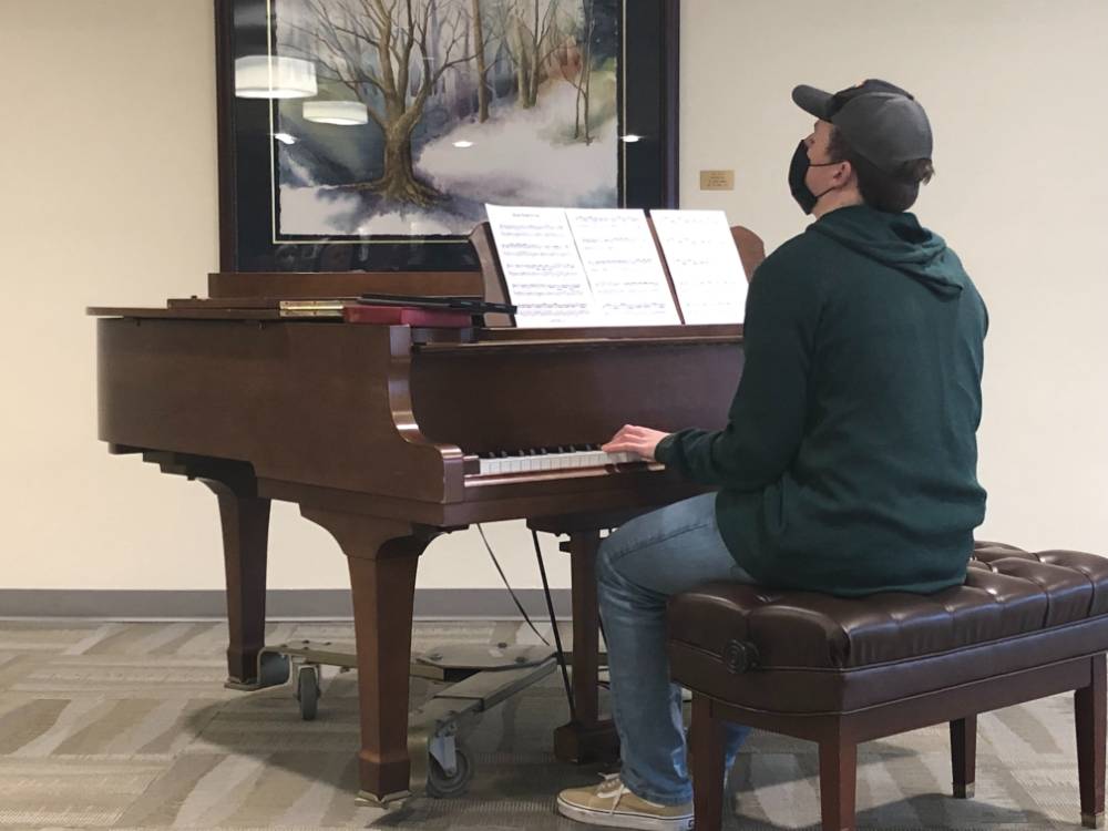Sage member playing the piano